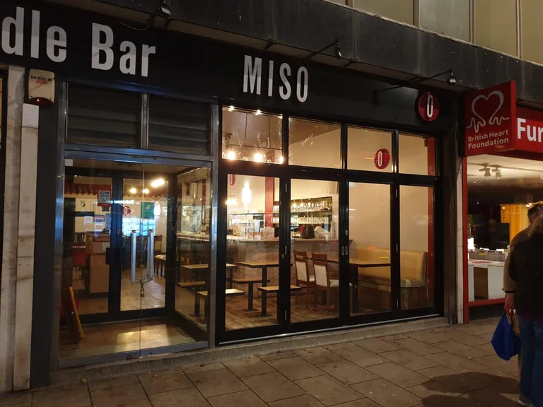 Black aluminium and glass commercial shopfront entrance.