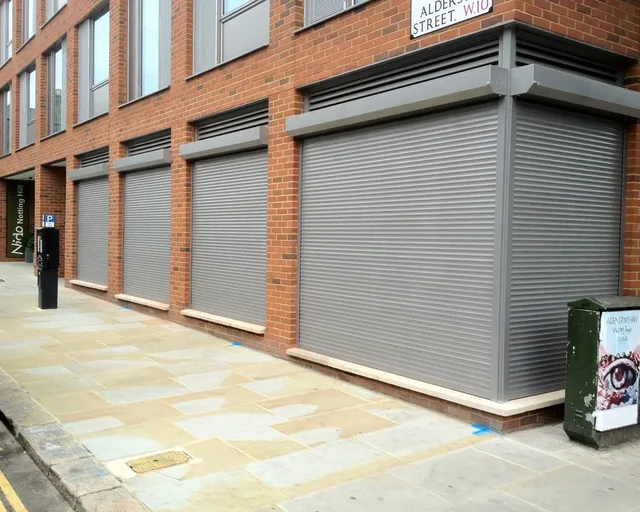 Commercial security shutters fitted around a corner frontage.