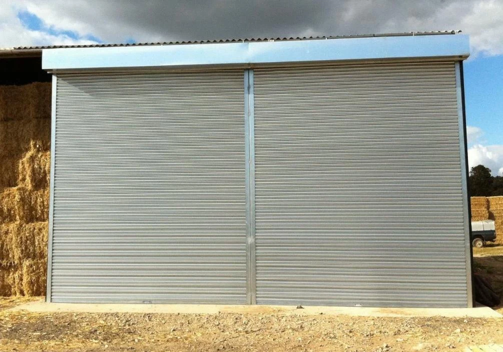 Grey roller shutters fitted across commercial openings