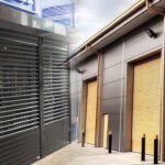 Aluminium shopfront with glass panels and open roller shutter