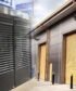 Aluminium shopfront with glass panels and open roller shutter