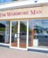 A set of closed metal roller shutters with scuff marks on a shopfront.